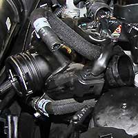 close up of various pipes on a mercedes car under bonnet some of which are used for the air conditioning system and showing signs of aging